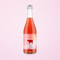 pét-nat natural wine bottle on a soft cotton-candy gradient