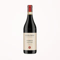 red natural wine bottle on a soft cotton-candy gradient