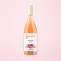 rosé natural wine bottle on a soft cotton-candy gradient