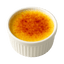 Delicious creamy crème brûlée topped with a caramelized sugar crust in a white ramekin.