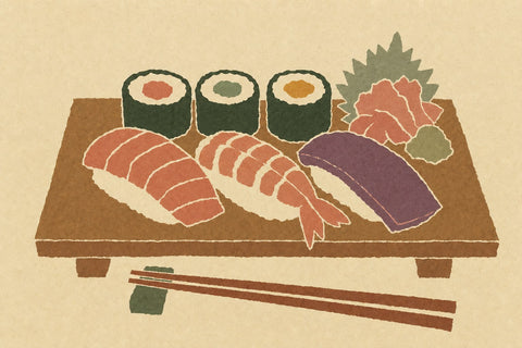 Paper-cutout illustration of nigiri and maki sushi on a wooden board with chopsticks