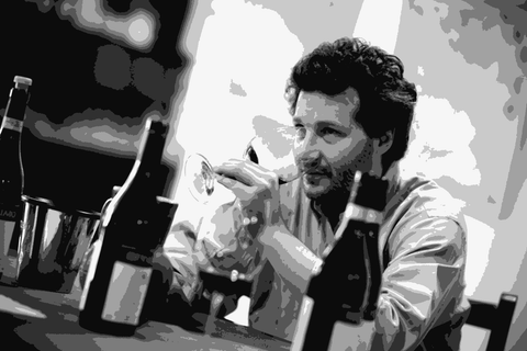 Alfio Cavallotto tasting a glass of Barolo in the family cellar