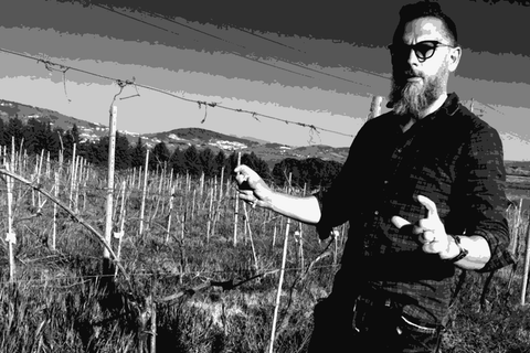 Winemaker Danilo Marcucci standing among the vines at Ceppaiolo in Umbria