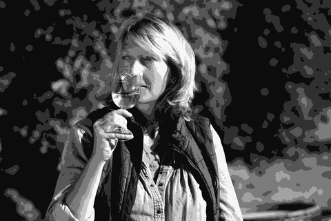 Winemaker Athénaïs de Béru tasting a glass of white wine outdoors at Château de Béru