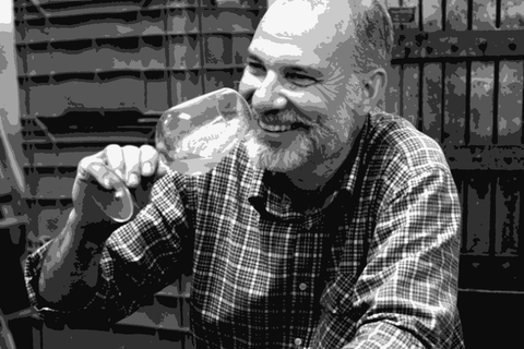 Costadila founder Ernesto Cattel tasting a glass of his col fondo wine