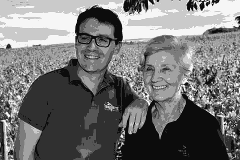Nicole Chanrion and Romain Chanrion of Domaine de la Voute des Crozes standing in their vineyard on Mont Brouilly