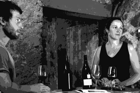 Paul Esteve and Chrystelle Vareille of Domaine des Miquettes tasting in their cellar with bottles and rock samples on the table