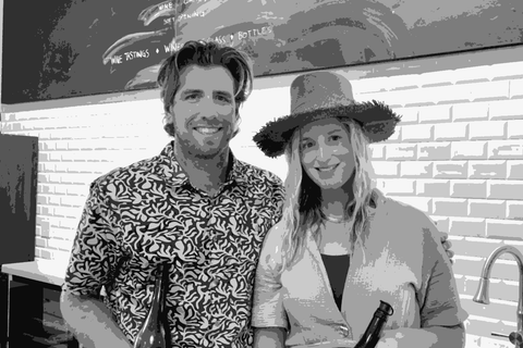 Tyler Eck and Rachel Goffinet Eck of Dunites Wine Co. holding bottles in their tasting room