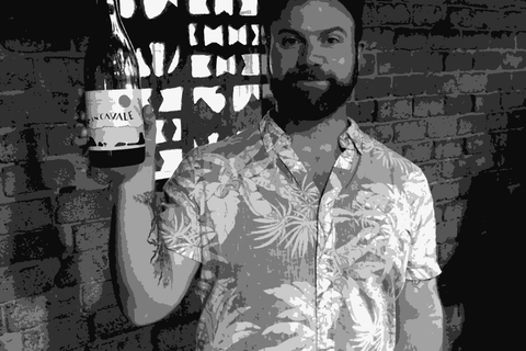 Wolfgang Weber of En Cavale holding a bottle of his California natural wine