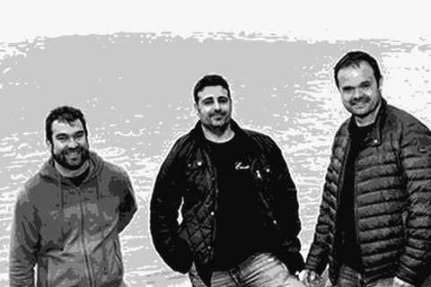 The four founders of Envinate standing on a cliff above the Atlantic coast of Tenerife