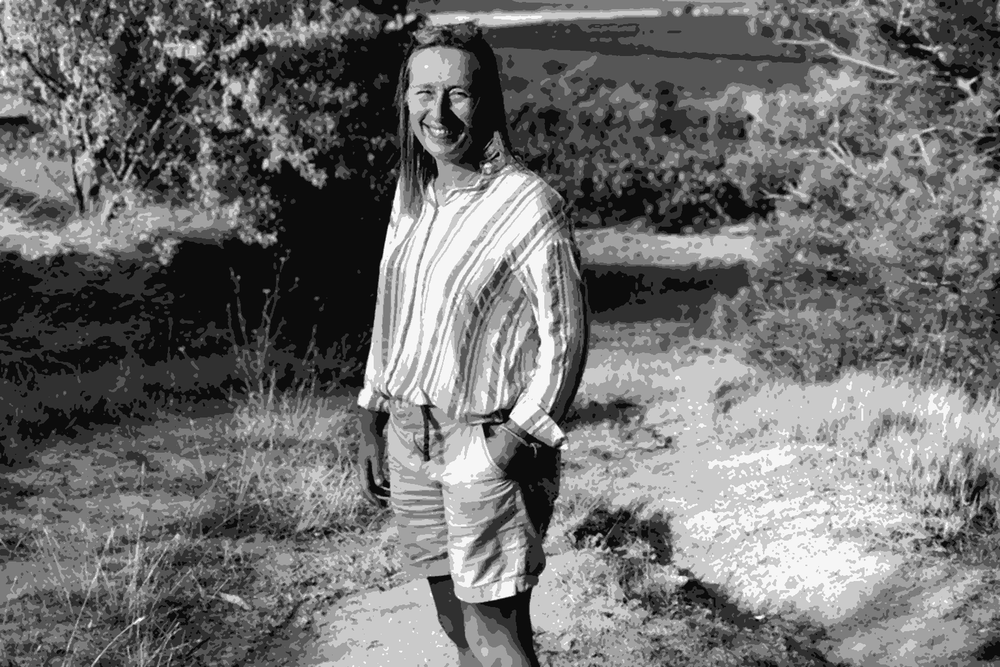 Laetitia Ourliac of Domaine Fond Cypres standing on a path beside the Corbieres vineyards