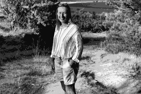 Laetitia Ourliac of Domaine Fond Cypres standing on a path beside the Corbieres vineyards