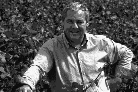 Winemaker Frédéric Cossard smiling among the vines in Burgundy