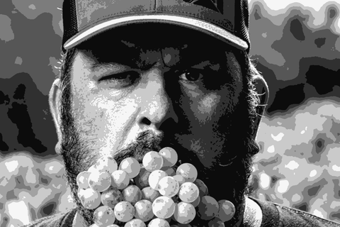 Fredi Torres in his Catalonian vineyard holding a cluster of grapes