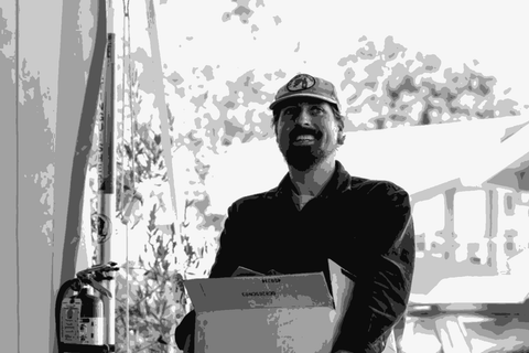 Jack Sporer, winemaker of FRES.CO, carrying a box outside his Sonoma winery