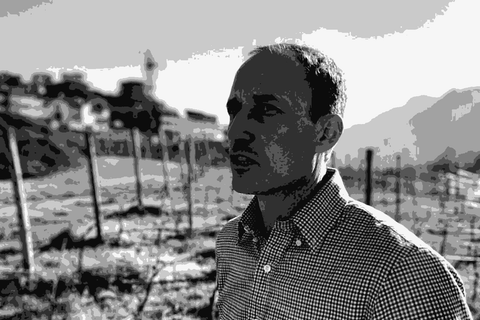 Winemaker Matteo Furlani standing in his alpine vineyard above Trento