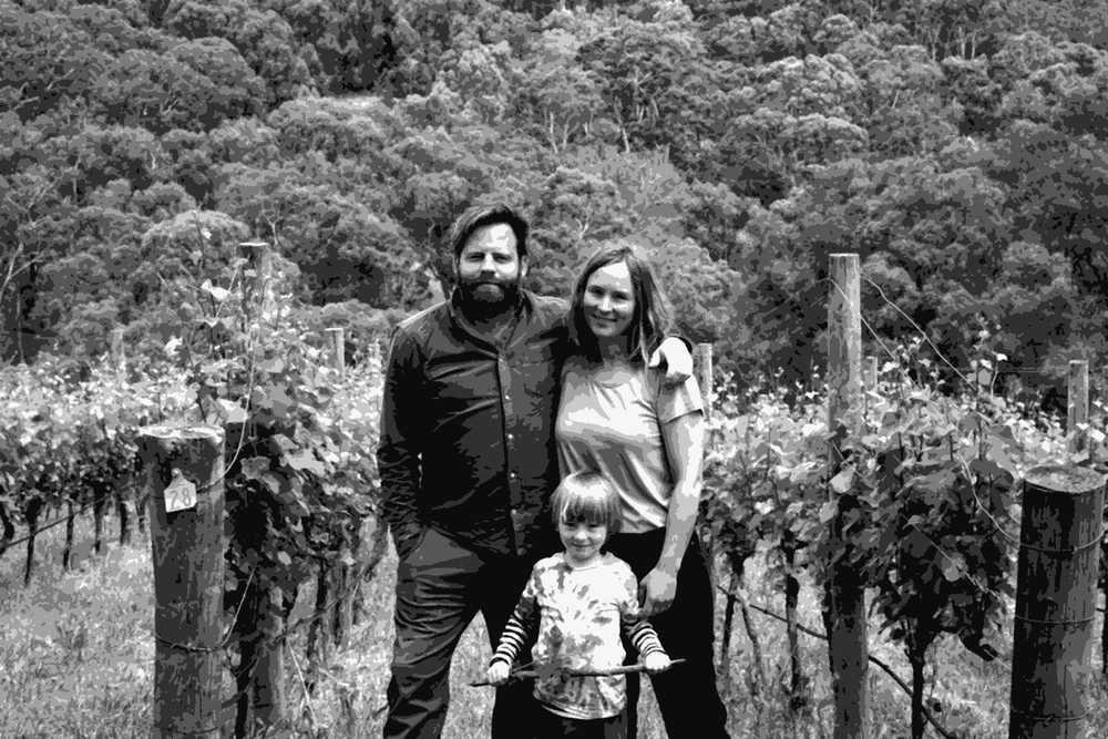 Gareth and Rainbo Belton of Gentle Folk standing with their child in their Basket Range vineyard