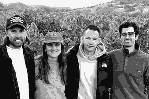 The Good Boy Wine team standing in a Central Coast vineyard at dusk