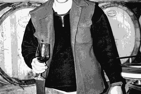 Henri Milan with a glass of wine in the barrel cellar of Domaine Milan, Saint-Remy-de-Provence