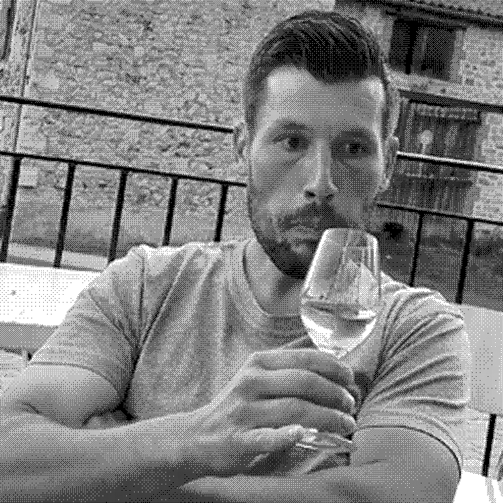 Henri Chauvet, natural wine producer, at his domaine in Boudes, Auvergne, France, holding a glass of wine