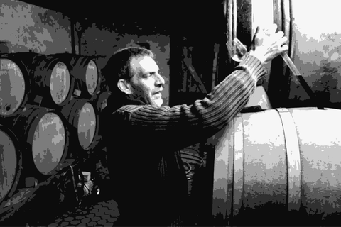 Jean-Marc Dreyer drawing wine from barrel in his Alsace cellar