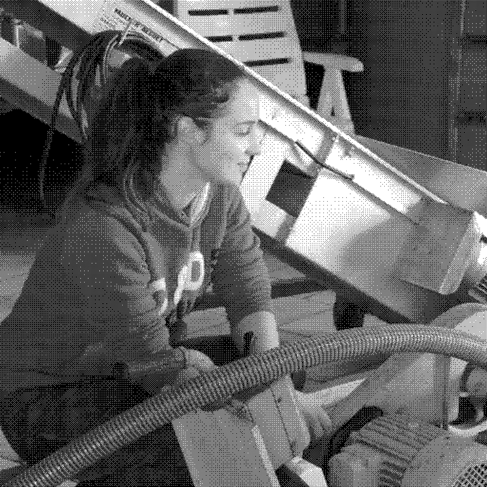 Barbara Lebled, natural wine producer, kneeling at the press in her cellar in the Loire Valley, France