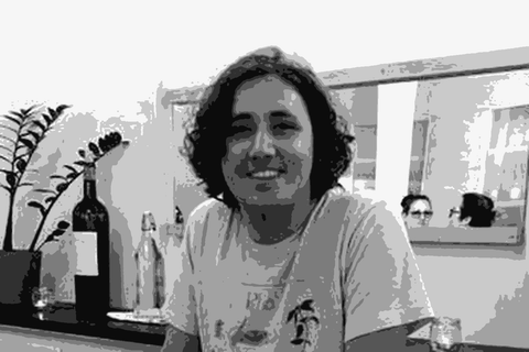 Chad Hinds of Methode Sauvage behind a bar at a wine tasting with bottles in front of him