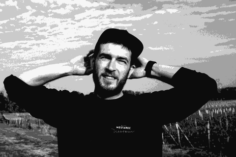 Milan Nestarec in his vineyard in Velke Bilovice, South Moravia, wearing a black cap and sweatshirt with his name on it