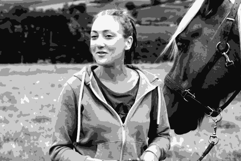 Nathalie Banes standing with her horse Hulot in the Beaujolais hills