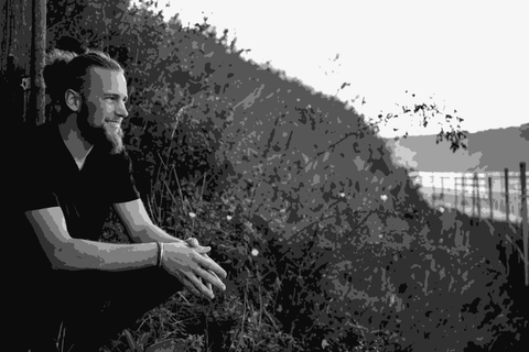 Josef Schenter crouching in the Nibiru vineyard in Kamptal, Austria