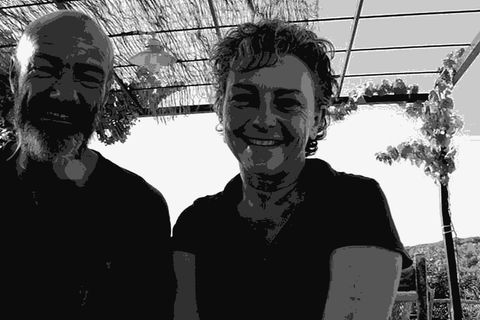 Massimo Marchiori and Antonella Gerosa, founders of Partida Creus, smiling together outdoors at the estate in Bonastre
