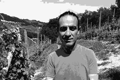 Ferdinando Principiano holding a piece of limestone soil in his Barolo vineyard