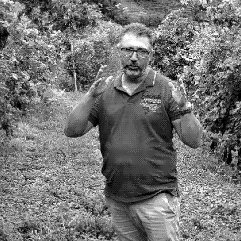 Ruge, natural wine producer in Valdobbiadene, Veneto, Italy, standing in his Prosecco Superiore vineyard