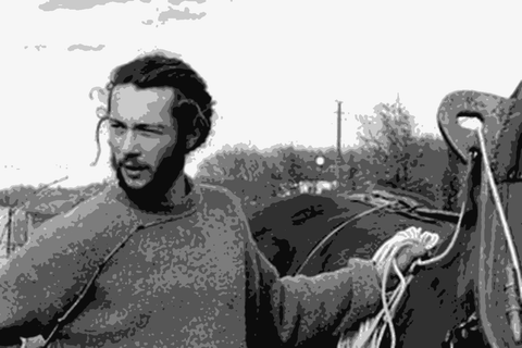 Simon Busser standing with his horse in a Cahors vineyard