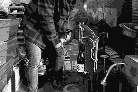 Lisanne van Son of Sonshine Vins corking bottles in her troglodyte cave cellar in the Loire Valley