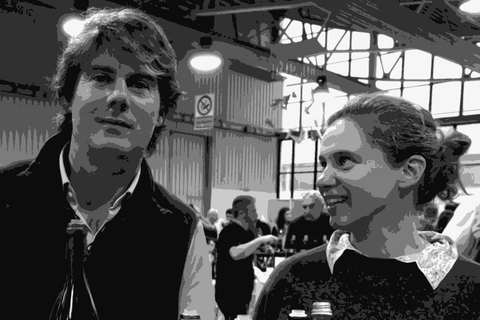 Guido Zampaglione and Igiea Zampaglione of Tenuta Grillo at a wine fair, holding bottles