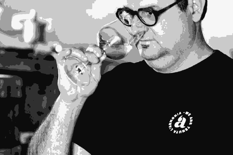 Andrea Pendin of Tenuta l'Armonia tasting wine from a glass in his cellar