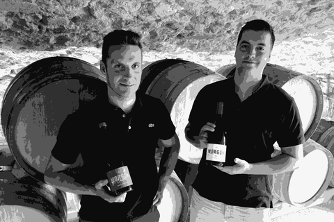 Thibault Ducroux and his brother Dimitri holding bottles of Morgon in their barrel cellar
