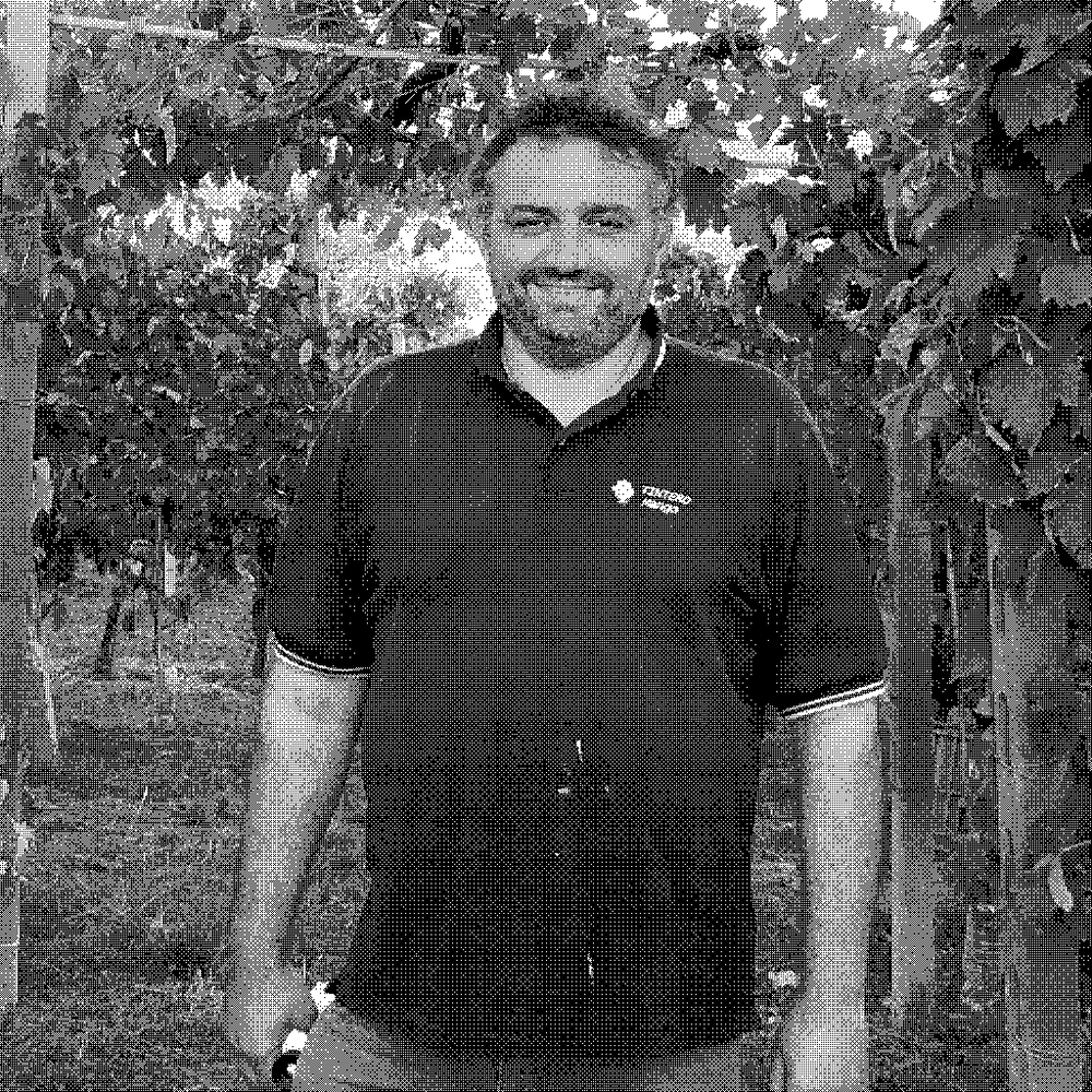 Marco Tintero, natural wine producer, standing in his vineyard in Mango, Piedmont, Italy