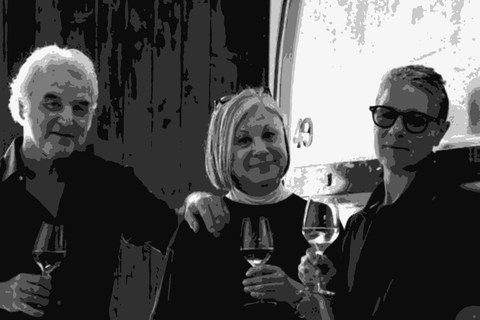 Oliviero, Cinzia, and Palmira Visintini holding wine glasses in their cellar