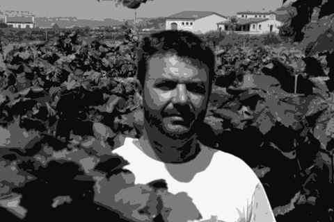 Ramon Jané standing among his Xarel-lo vines in the Penedes, Mas Candi farmhouse visible behind