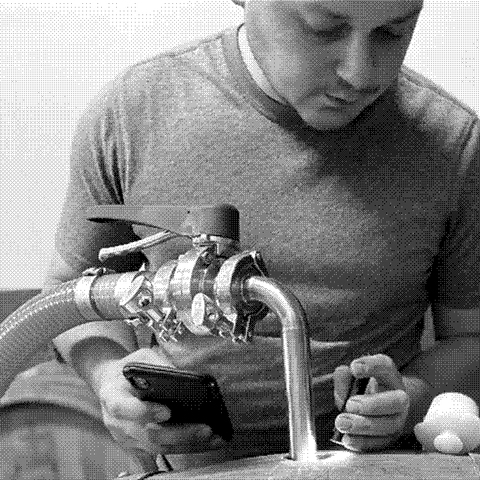 Alex Pomerantz, co-founder of Welcome Stranger, natural wine producer in California, pulling a barrel sample in his cellar