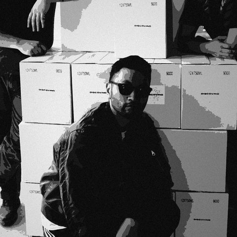 A Wonderwerk winemaker among stacked cases at the winery, black and white