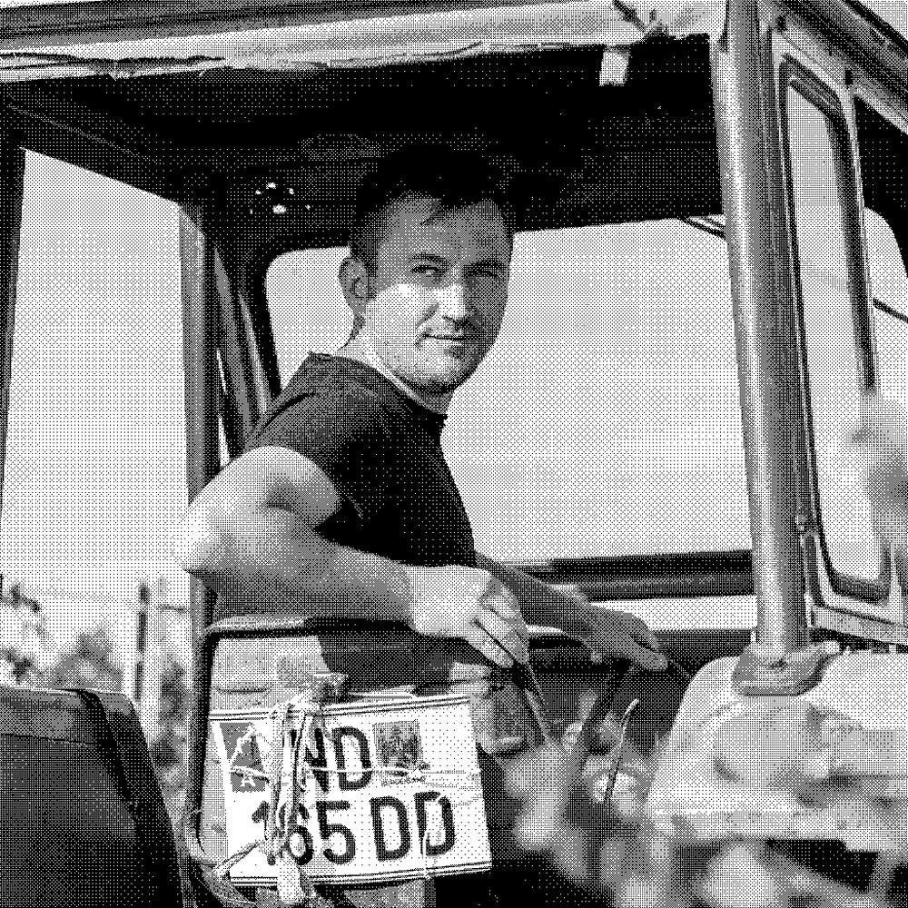 Andreas Ziniel, natural wine producer, on his tractor among the vines in Burgenland, Austria