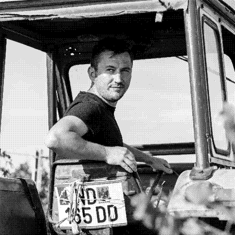 Andreas Ziniel, natural wine producer, on his tractor among the vines in Burgenland, Austria