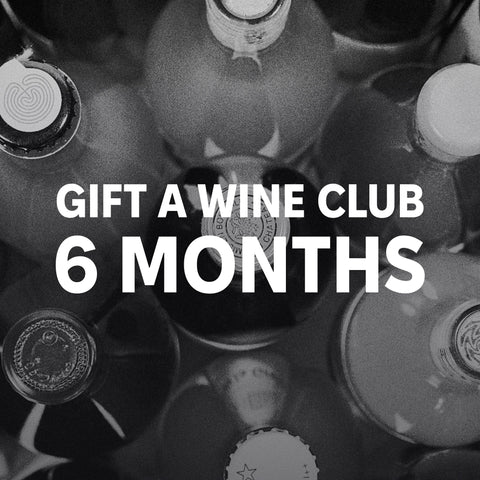 Gift a Wine Club: 6 Months: white text over a black-and-white photo of wine bottles seen from above