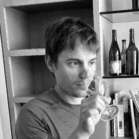 Valentin Morel, natural wine producer, tasting wine in his cellar in Poligny, Jura, France